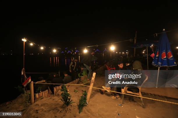 Iraqi youth enjoy at Tahrir beach in Baghdad, Iraq on December 23, 2109. Young protesters in Baghdad, continue to protest the government and also...