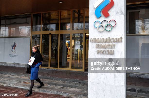 Woman walks out of the Russian Olympic Committee headquarters in Moscow on December 24, 2019 following meetings with the Russian anti-doping agency...