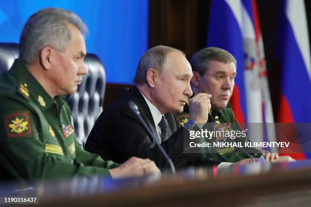 Russian President Vladimir Putin and Russian Defence Minister Sergei Shoigu take part in the annual meeting of the Defence Ministry board, in Moscow...