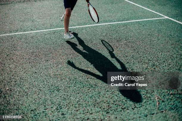 child tennis player shadow - abstract tennis player stock pictures, royalty-free photos & images