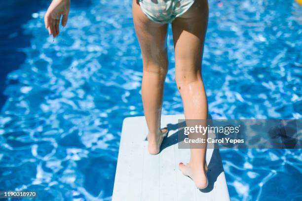 child ready to jump off diving board into pool.armband - girl wet casual clothing stock pictures, royalty-free photos & images