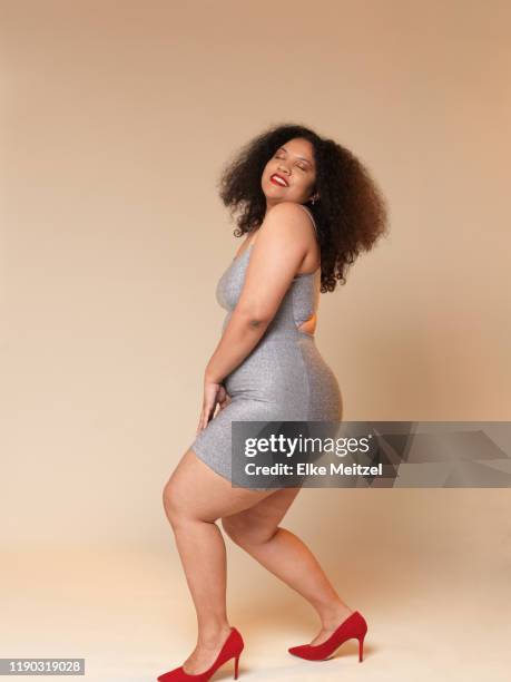 woman in a skin tight dress dancing - form fitted dress stock pictures, royalty-free photos & images