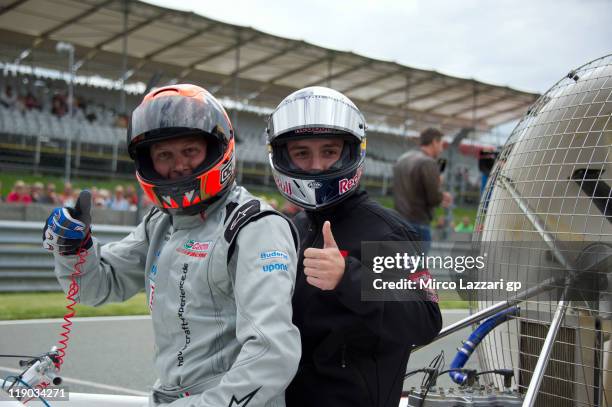 Michele Scanavino of Italy poses with Jonas Folger of Germany and Red Bull Ajo Motorsport on the hovercraft during the pre-event "Riders from the 3...