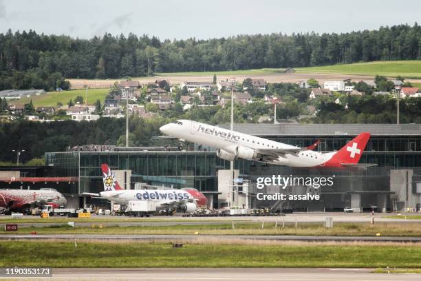 an embraer erj-190 from helvetic airways takes off from zurich airport kloten in switzerland - airbus concept cabin stock pictures, royalty-free photos & images