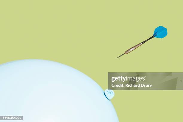 dart flying towards balloon - emergencies and disasters stock pictures, royalty-free photos & images