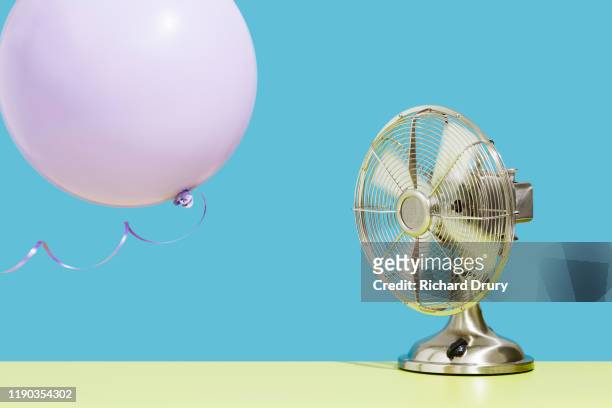 fan blowing balloon - electric fan stock pictures, royalty-free photos & images