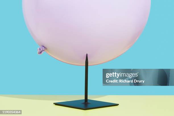 balloon stuck on a metal spike - blowing up balloon stock-fotos und bilder