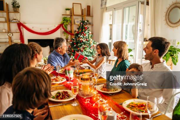 hispanic family enjoying christmas dinner and gift-giving - argentina traditional food stock pictures, royalty-free photos & images