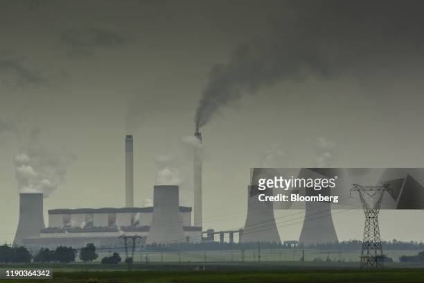 Emissions rise from the cooling towers of the Eskom Holdings SOC Ltd. Tutuka coal-fired power station in Mpumalanga, South Africa, on Monday, Dec....