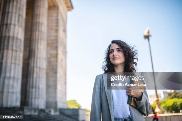 outdoor portrait of pensive female law student - regulation stock-fotos und bilder