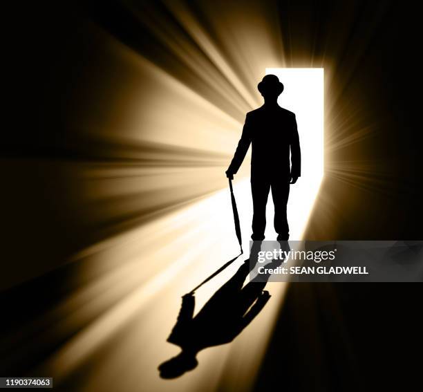 man standing in doorway light white umbrella - bailiffs fotografías e imágenes de stock