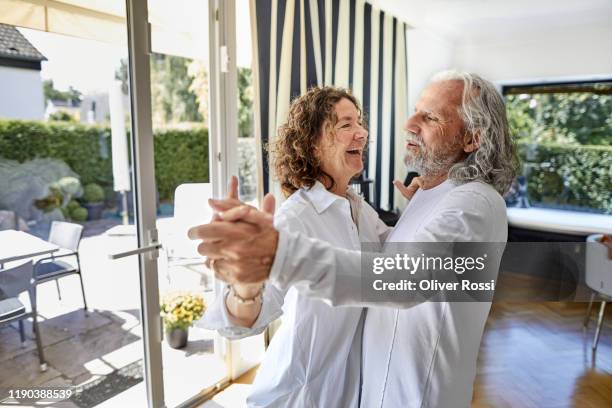 happy senior couple dancing at home - couple dancing at home stock pictures, royalty-free photos & images