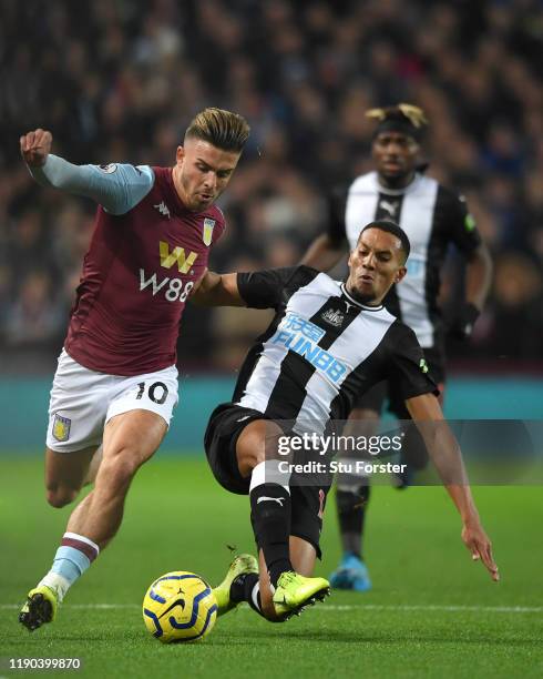 Aston Villa player Jack Grealish holds off the challenge of Isaac Hayden during the Premier League match between Aston Villa and Newcastle United at...