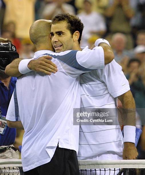 Pete Sampras and Andre Agassi embrace at the net after Sampras won the U.S. Open in Flushing, New York, September 8, 2002. Sampras defeated...