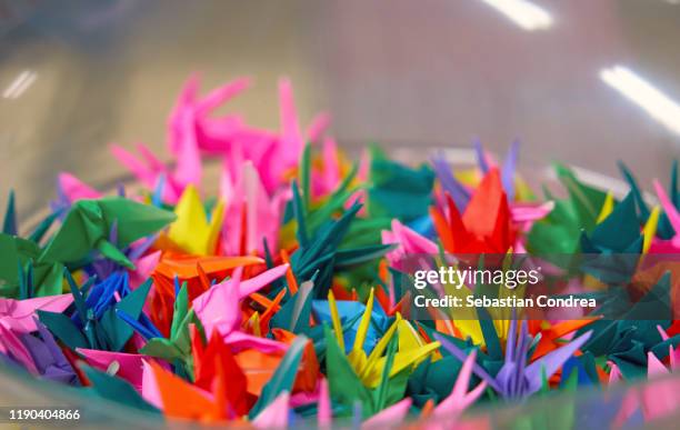 strings of colorful origami birds from a kyoto temple, japan culture travel - origami a forma di gru foto e immagini stock