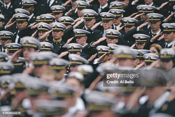 Navy Officer Cadets from the United States Naval Academy at Annapolis salute before the NCAA Division 1- A Army-Navy college football game on 4th...