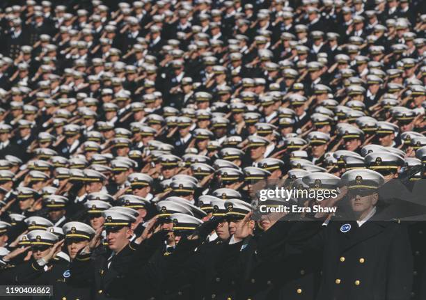 Navy Officer Cadets from the United States Naval Academy at Annapolis salute before the NCAA Division 1- A Army-Navy college football game on 4th...