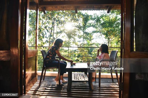 Mother and daughter having morning tea in the balcony
