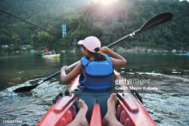 girl kayaking in the river - sports india stockfoto's en -beelden