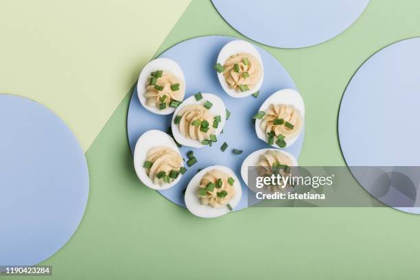 deviled eggs with green onion, easter party snack - easter dinner stock pictures, royalty-free photos & images