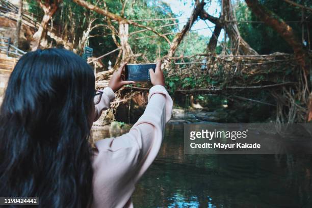 Girl taking photo using mobile camera