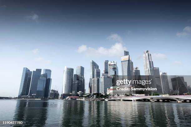 singapore urban skyline against marina bay - singapore city day stock pictures, royalty-free photos & images