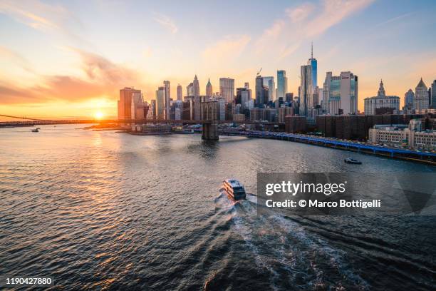 hudson river and lower manhattan skyline at sunset, new york city - hudson river stock pictures, royalty-free photos & images