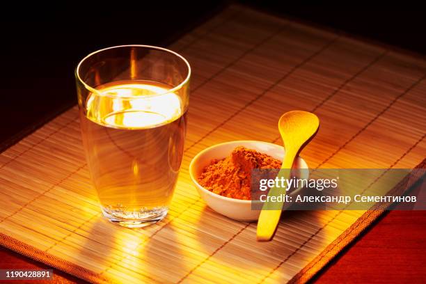 solar spice a turmeric with water. fragrant spice with vitamins. - powder tea stock pictures, royalty-free photos & images