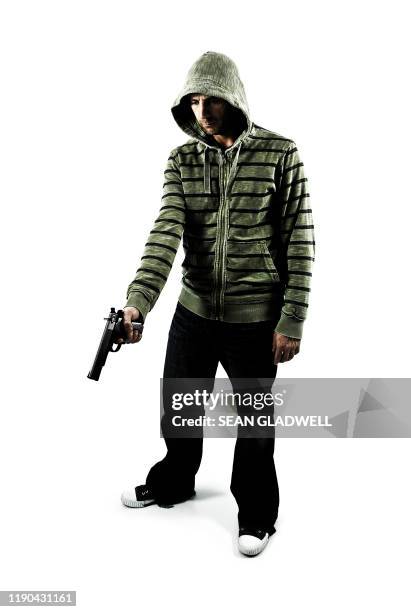 man holding gun - hand holding gun stockfoto's en -beelden