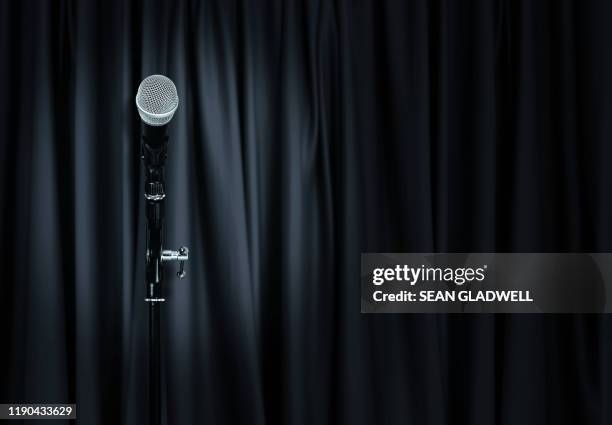 microphone on stand and black drapes - black awards stock pictures, royalty-free photos & images