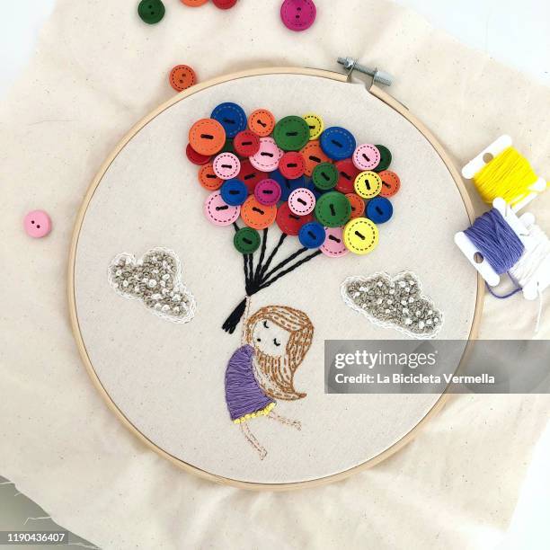 embroidered girl with balloons on frame - embroidery frame stock pictures, royalty-free photos & images