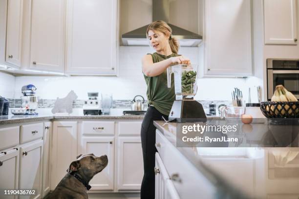 woman mixing protein smoothie after home workout - mixer stock pictures, royalty-free photos & images