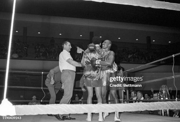 Middleweight Marvin Hagler is a happy fighter as he wears winners medal and waves a small American flag after defeating Terry Dobbs of the Marine...