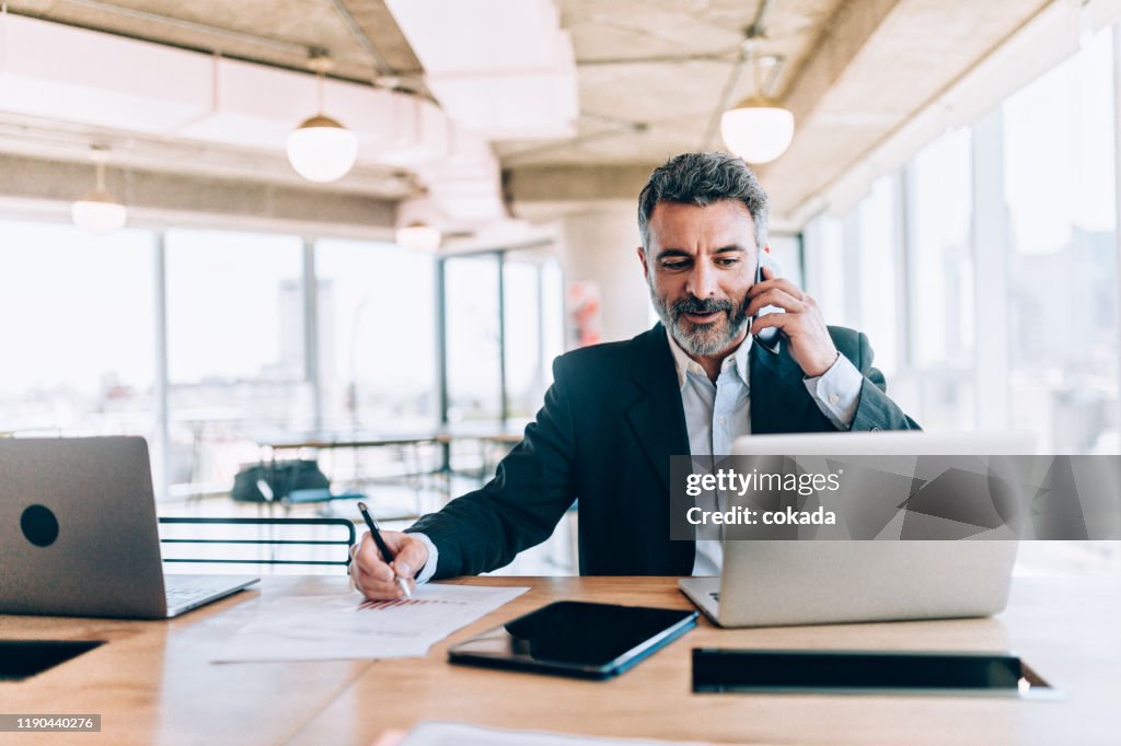 Businessman at the office talking on cell phone