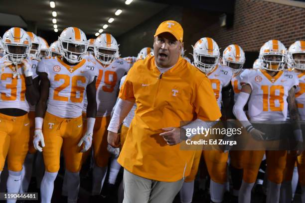 Head coach Jeremy Pruitt of the Tennessee Volunteers leads his team to the field against the Missouri Tigers at Memorial Stadium on November 23, 2019...