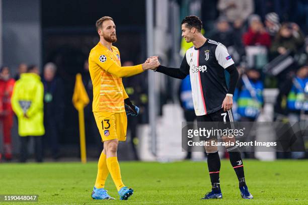 Goalkeeper Jan Oblak of Atletico de Madrid shake hands with Cristiano Ronaldo of Juventus during the UEFA Champions League group D match between...