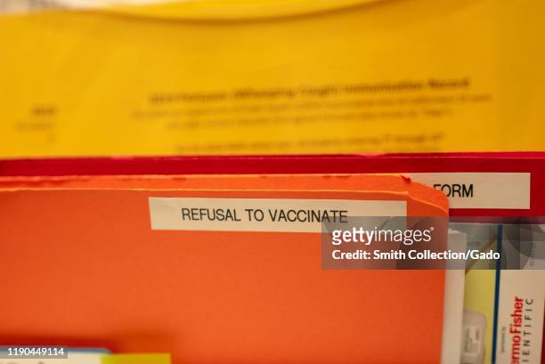 Close-up of folder containing medical forms and labeled Refusal to Vaccinate in a pediatrician's office in San Ramon, California, November 25, 2019....