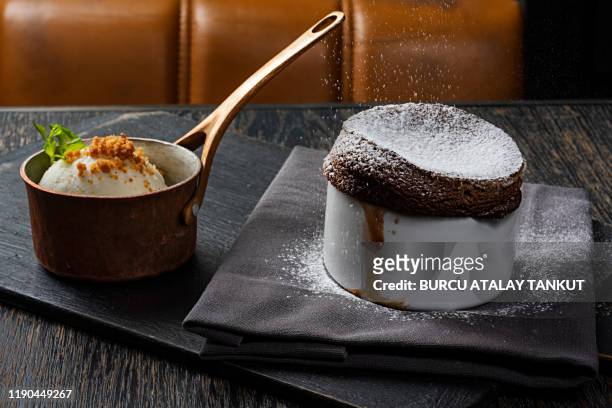 chocolate souffle with ice cream - chocolate souffle stock-fotos und bilder