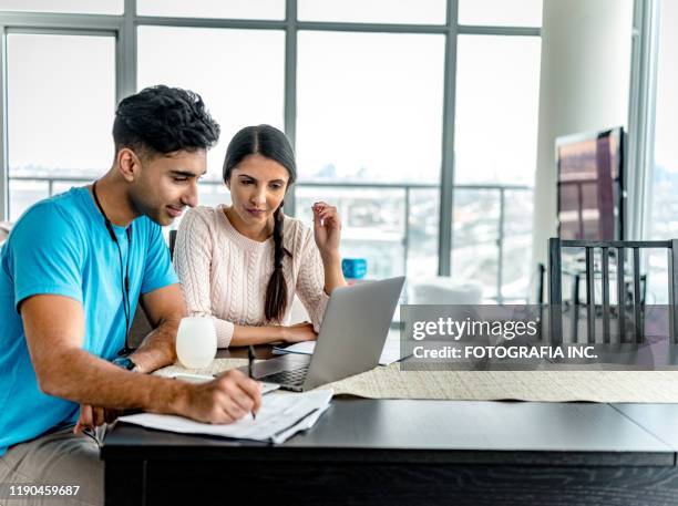 young indian couple doing home budget - indian economy business and finance stock pictures, royalty-free photos & images