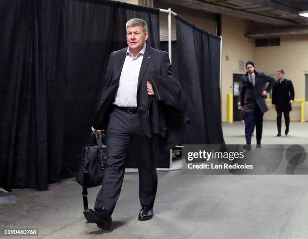Head Coach of the Calgary Flames Bill Peters enters the building on way to the locker room prior to his game against the Philadelphia Flyers on...