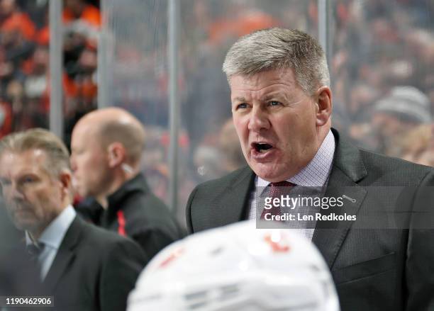 Head Coach of the Calgary Flames Bill Peters reacts to a play on the ice against the Philadelphia Flyers on November 23, 2019 at the Wells Fargo...