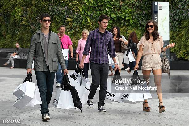 Gregg Sulkin and Electra Formosa and David Henrie from Disney's 'Wizards of Waverly Place' sighted shopping at DKNY in Westfield shopping centre at...