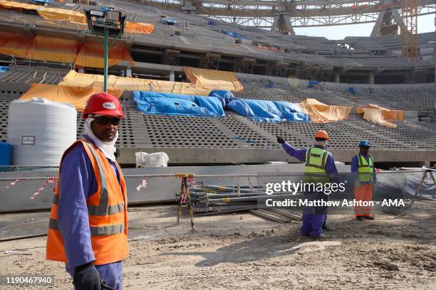 Construction workers in the Lusail Iconic Stadium in Doha, Qatar. Venue for the FIFA Qatar World Cup 2022, Doha, Qatar on December 21, 2019 in Doha,...