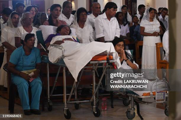 Survivors of the Easter Sunday bomb attacks attend midnight mass at St. Sebastian's Church in Negombo on December 25, 2019. Archbishop of Colombo...