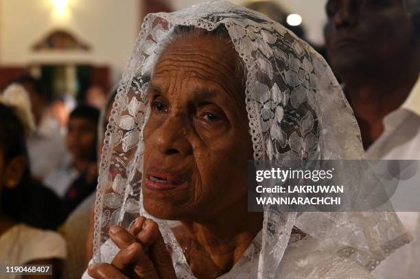 Christian devotee attends midnight mass at St. Sebastian's Church in Negombo on December 24, 2019. Archbishop of Colombo Malcolm Ranjith attended St....