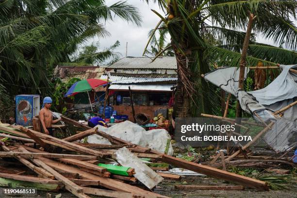 Resident looks at a house damaged at the height of Typhoon Phanfone in Tacloban, Leyte province in the central Philippines on December 25, 2019....