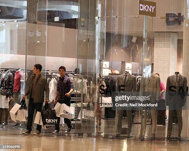 Gregg Sulkin and David Henrie from Disney's 'Wizards of Waverly Place' shopping at DKNY in Westfield shopping centre at Westfield on July 14, 2011 in...