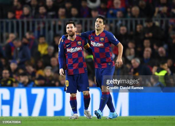Luis Suarez of FC Barcelona celebrates with teammate Lionel Messi after scoring his team's first goal during the UEFA Champions League group F match...