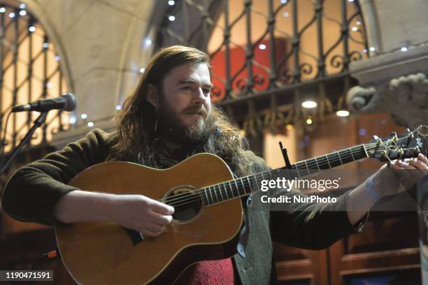 John Francis Flynn performs during the annual Christmas Eve busk in aid of the Dublin Simon Community outside the Gaiety Theater in Dublin. Hundreds...