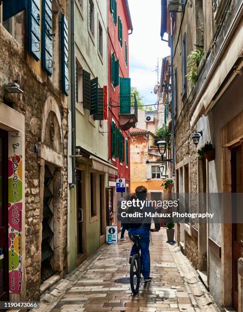 a cyclist in a typical alley of the old town of zadar. - kroatien zadar stock pictures, royalty-free photos & images